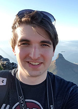 Student portrait, male, short brown hair, sunglasses 